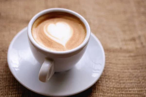 One White Cup Coffee Heart Stands Windowsill Burlap Fabric Loneliness — Stock Photo, Image