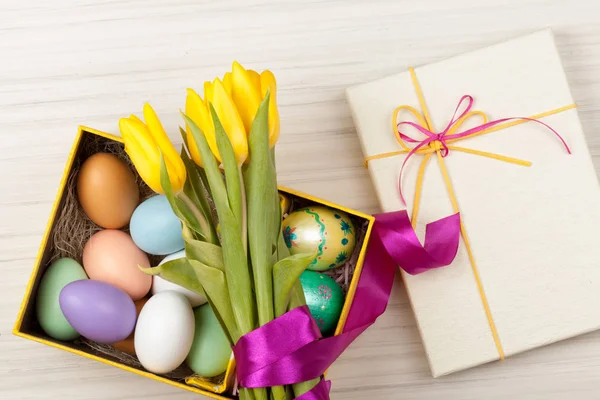 Œufs de Pâques dans une boîte avec des tulipes colorées — Photo