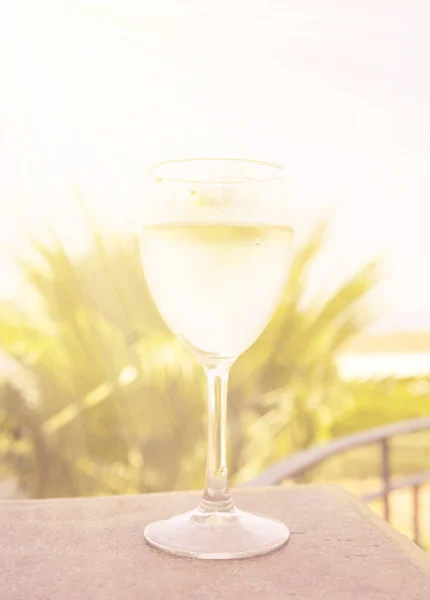 Glass of white wine over natural background — Stock Photo, Image