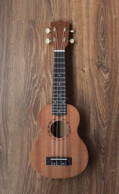 Kahverengi ukulele gitar portresi doku duvarında, klasik esmer ton tatili müzik molası ya da metin alanınız için resim konsepti