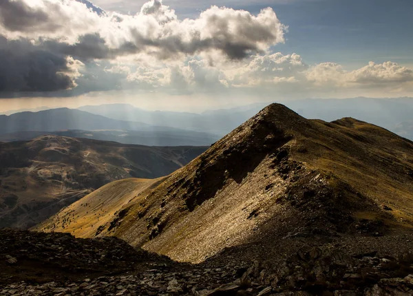 Mountain Side Sunlit by Sun Rays in the Pyrenees