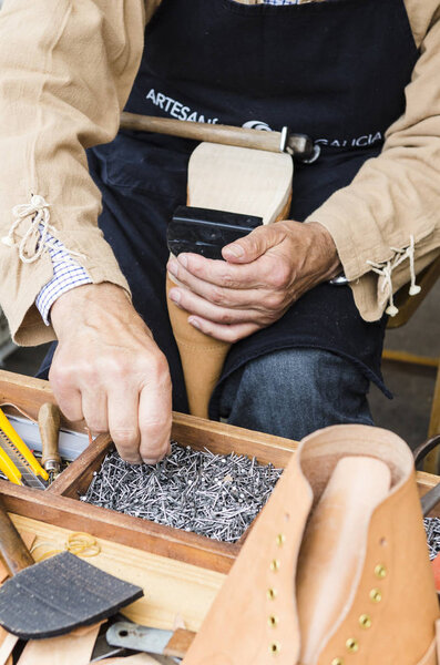 Shoemaker working in a fair