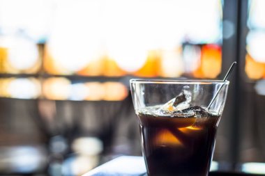 Kahve masasında buzlu bir bardak kahve..