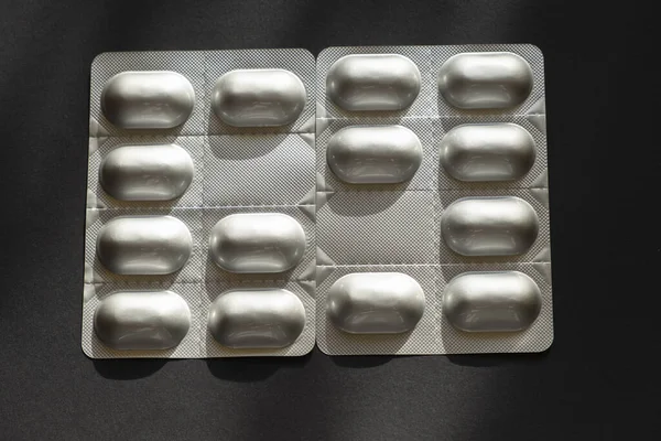 Detail of a closed silver blister with pills or medicines.