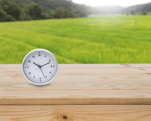 Clock Wood Table Green Fields Background — Stock Photo, Image
