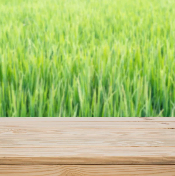 Wood table top with green fields background — Stock Photo, Image