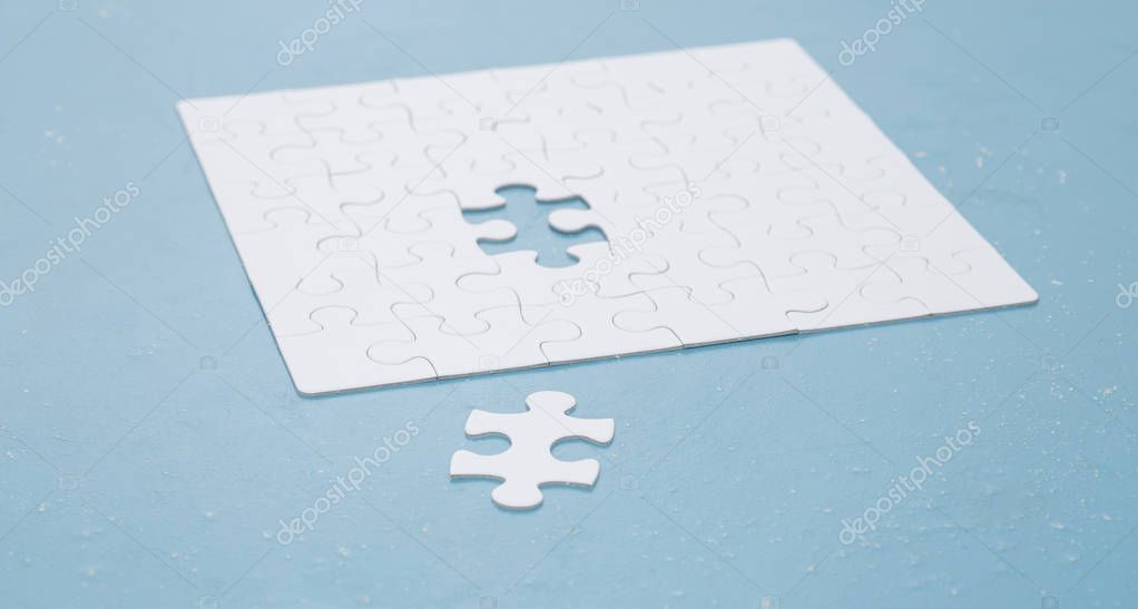 Jigsaw puzzle on grunge blue table background