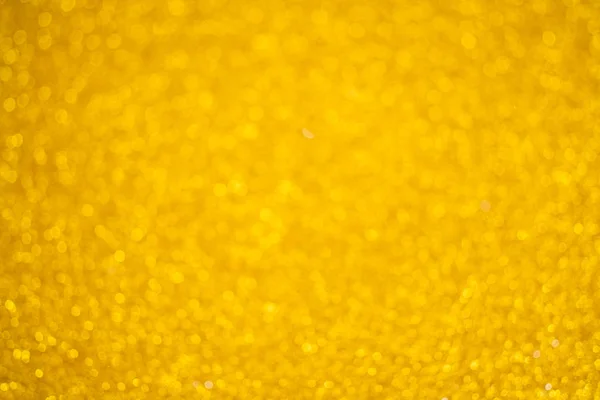 Abstraktní rozmazané zlaté třpytky pozadí bokeh — Stock fotografie