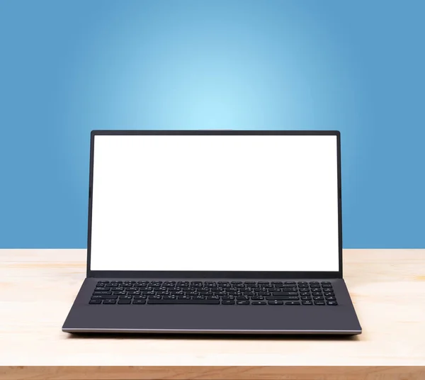 Blank white screen laptop computer on wood table — Stock Photo, Image