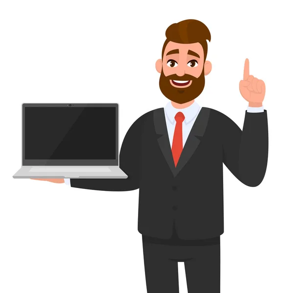 Positiv forretningsmand i formel bedrift eller viser blank skærm af en bærbar computer og peger op hånd finger, gestus nummer et, ide. Moderne livsstil, teknologi enhed, gadget . – Stock-vektor
