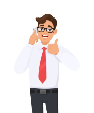 Positive young business man in formal speaking/talking on the mobile, cell or smart phone. Male character gesturing or making thumbs up sign with hand finger. Modern lifestyle, digital technology.