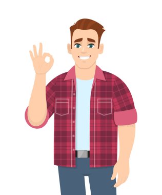 Şık bir genç adam iyi işaretler gösteriyor. Modayı takip eden biri tamam ya da parmaklarıyla güzel bir jest yapıyor. Erkek karakter tasarımı çizimi izole edildi. Vektör karikatür biçiminde insan duyguları ve ifadeleri kavramı.