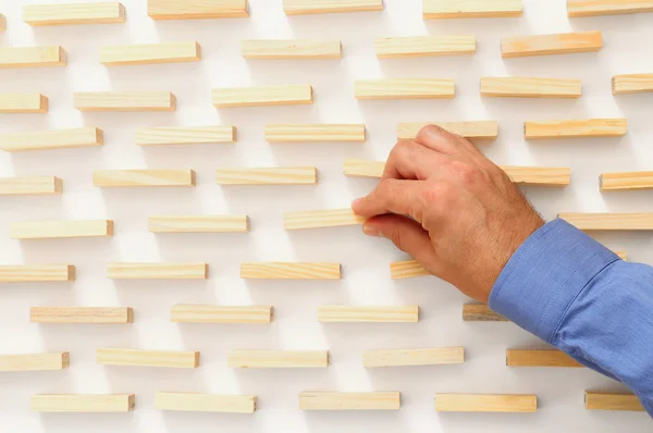 Man's hand ajusts brick — Stock Photo, Image