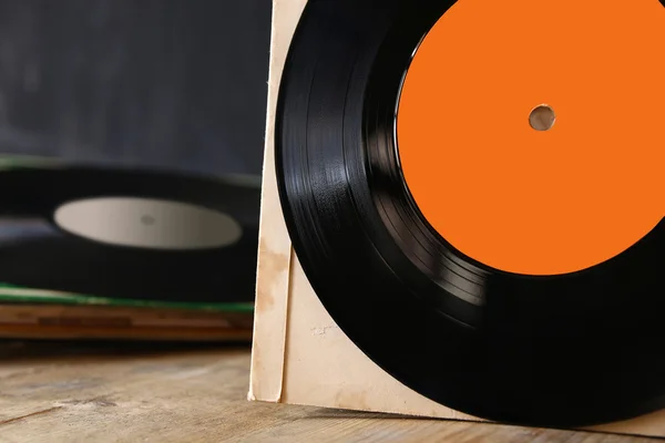 Close up of old records on wooden table — Stock Photo, Image