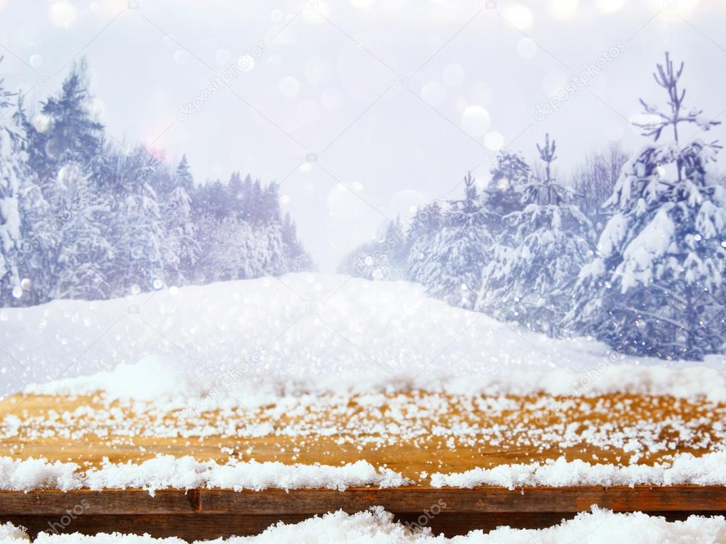 Empty wooden table in front of dreamy winter background