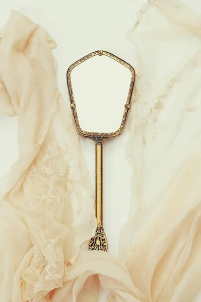 vintage hand mirror and lace scarf