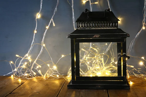 Fairy lights inside old lantern — Stock Photo, Image