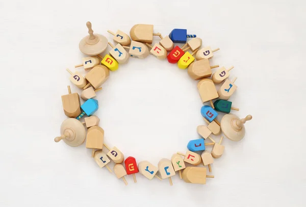 Jewish holiday Hanukkah with wooden dreidels (spinning top) — Stock Photo, Image