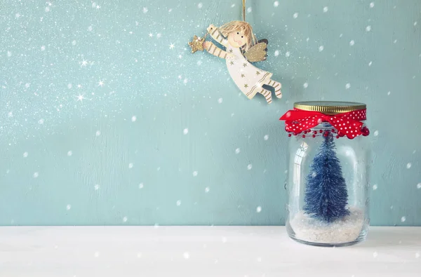 Mason jar with christmas tree and flying angel — Stock Photo, Image