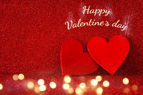 Valentines day background. Glitter red hearts on red background — Stock Photo, Image