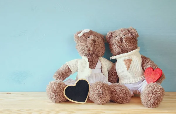 Pár aranyos teddy viseli, ül a fa tábla — Stock Fotó