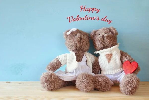 Couple of cute teddy bears holding heart