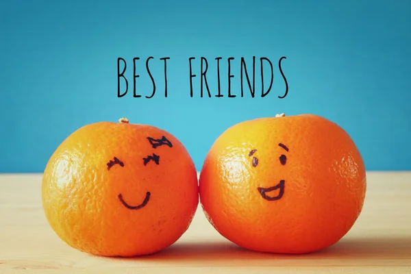 Image of two clementines with drawn smiley faces — Stock Photo, Image