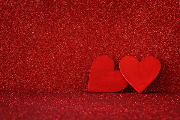 Røde hjerter av tre på rød, blank bakgrunn – stockfoto