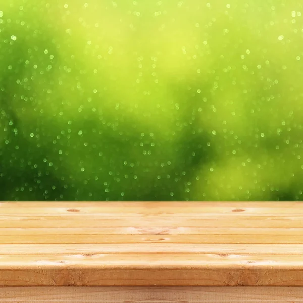 Empty table in front of green glitter — Stock Photo, Image