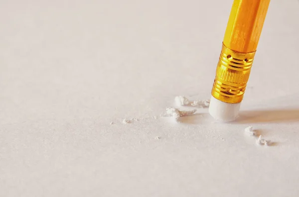 Pencil eraser removing a mistake on a paper — Stock Photo, Image