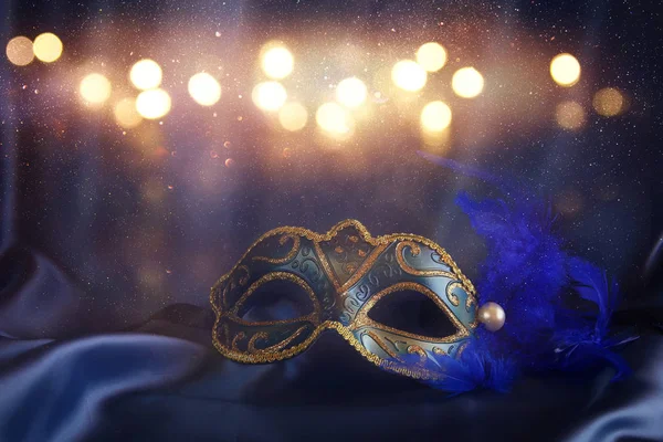 Elegant venetian mask on blue silk background — Stock Photo, Image