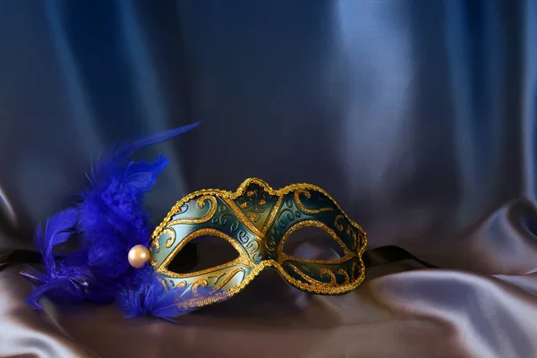 Elegant venetian mask on blue silk background — Stock Photo, Image