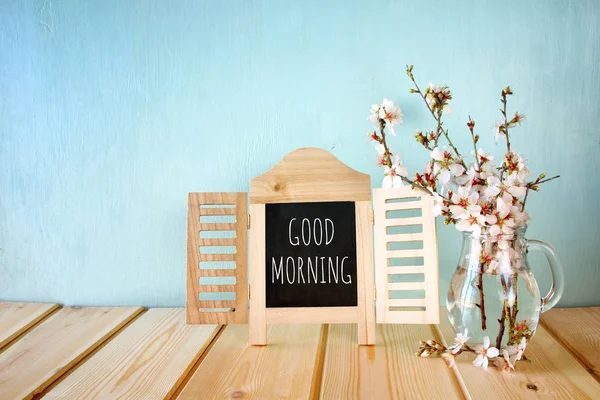 Spring white cherry blossoms tree next to blackboard — Stock Photo, Image