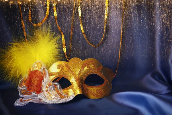 Gold venetian mask on blue silk background — Stock Photo, Image