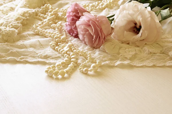 White delicate lace fabric and white flowers — Stock Photo, Image