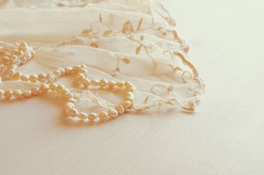 Arka plan beyaz hassas dantel kumaş ve inci.