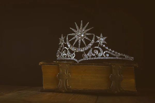 low key of diamond queen crown on old book