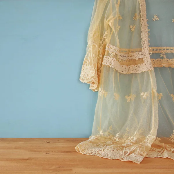 Vintage white crochet lace top in front of blue background — Stock Photo, Image