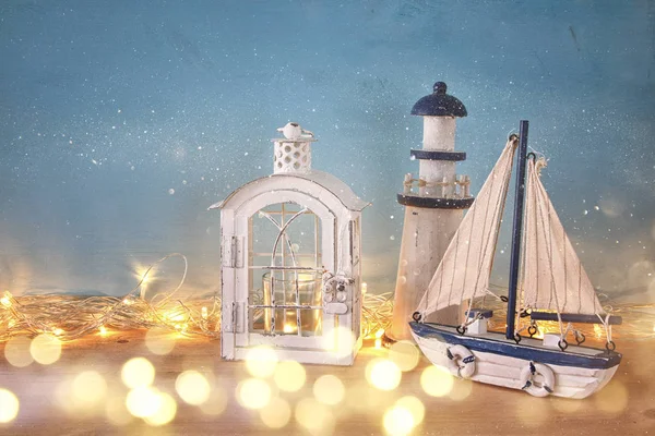 Nautical concept with sea life style objects and gold garland lights — Stock Photo, Image