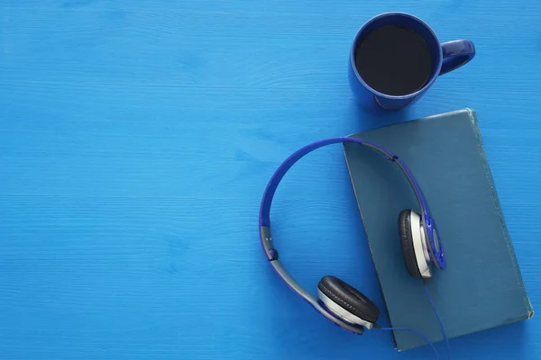 Tasse de café, vieux livre avec écouteurs — Photo