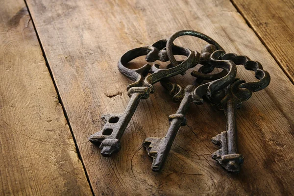 Image of antique keys on old wooden table