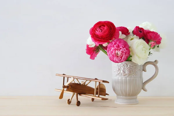 Rosses dans le vase vintage et vieux jouet d'avion — Photo