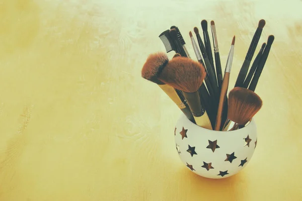 Set of professional makeup brushes on wooden table — Stock Photo, Image