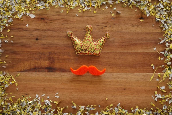 Top view image of funny red mustache and glitter crown. Father\'s day concept