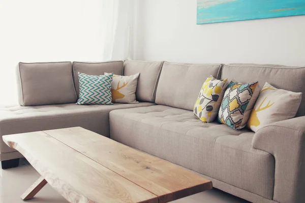 Wooden empty table in front of Living room sofa interior.