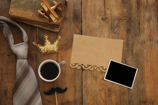 Old books, glitter crown, necktie and cup of coffee. Father's day concept — Stock Photo, Image