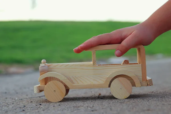 야외 공원에서에서도 나무로 되는 장난감 자동차를가지고 노는 아이 — 스톡 사진
