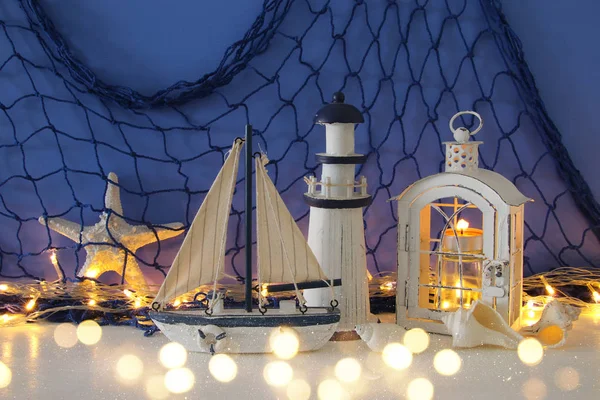Magische lantaarn met kaars licht en houten boot op de plank. Nautische concept — Stockfoto