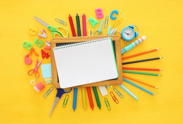 Back to school concept. Top view. School notebook on yellow wood — Stock Photo, Image