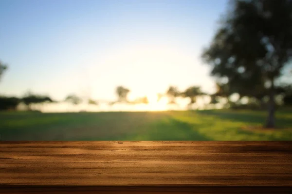 Порожній дерев'яний стіл перед мрійливим сільським фоном заходу сонця — стокове фото